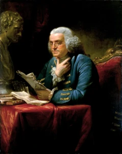 Benjamin Franklin working at his desk